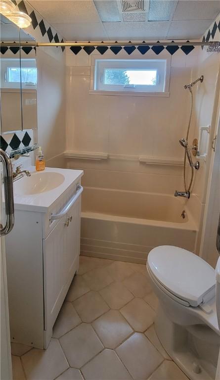 full bathroom with vanity, tile patterned floors, shower / washtub combination, and toilet