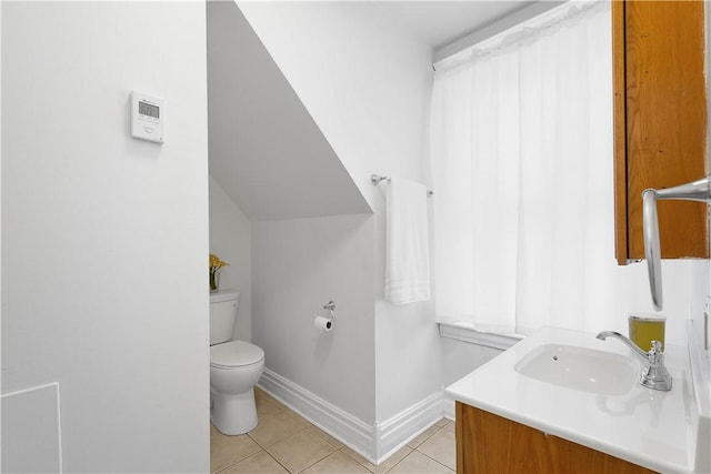 bathroom featuring vanity, tile patterned floors, and toilet