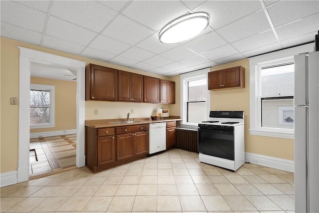 kitchen with a paneled ceiling, refrigerator, sink, white dishwasher, and gas range