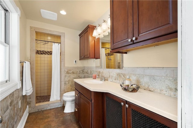 bathroom featuring tile walls, vanity, curtained shower, and toilet