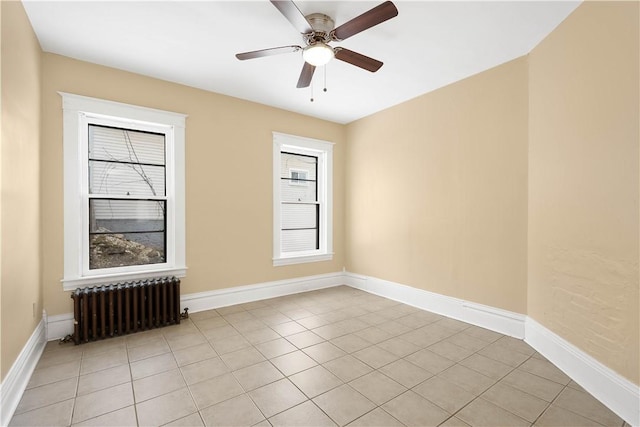 unfurnished room featuring radiator, light tile patterned floors, and ceiling fan