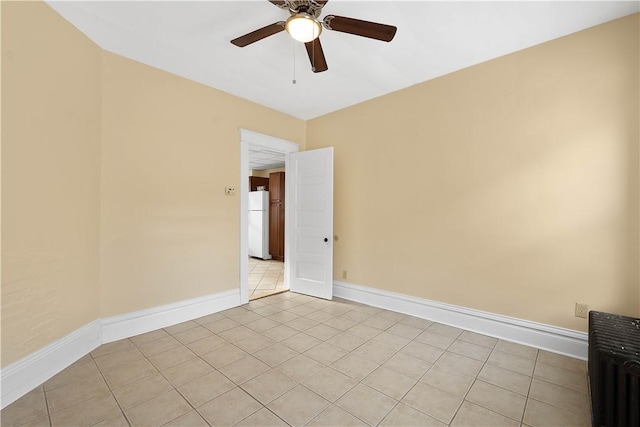 empty room featuring ceiling fan and light tile patterned flooring