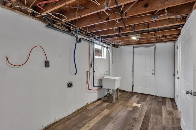 basement with sink and dark hardwood / wood-style floors