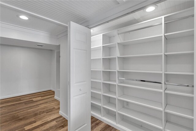 spacious closet with dark hardwood / wood-style floors