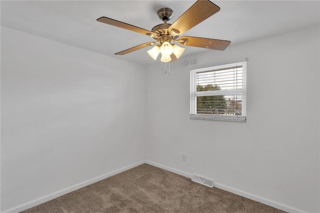 carpeted spare room with ceiling fan