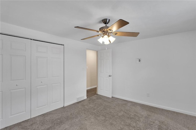 unfurnished bedroom featuring ceiling fan, carpet flooring, and a closet