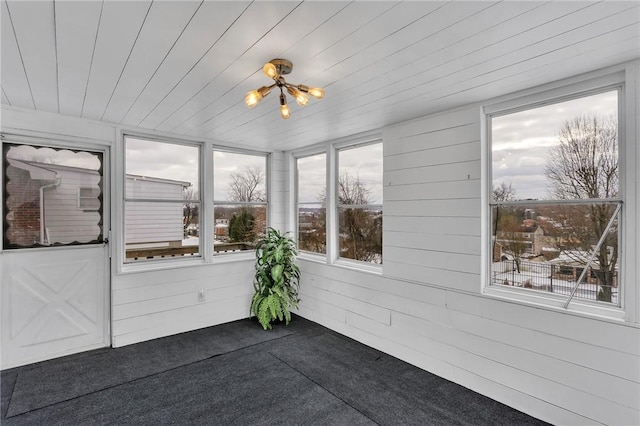 unfurnished sunroom with wooden ceiling