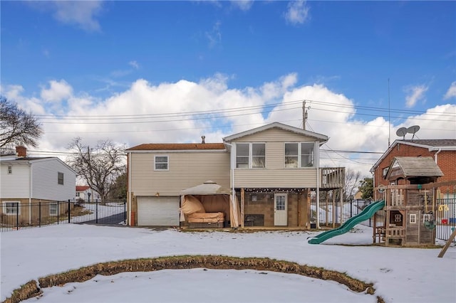 exterior space featuring a garage and a playground