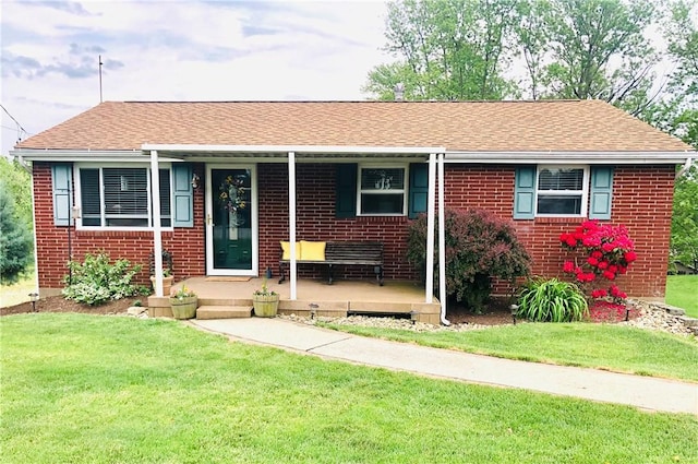 view of front of house featuring covered porch and a front lawn