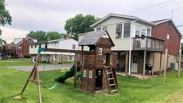 view of jungle gym with central air condition unit and a lawn