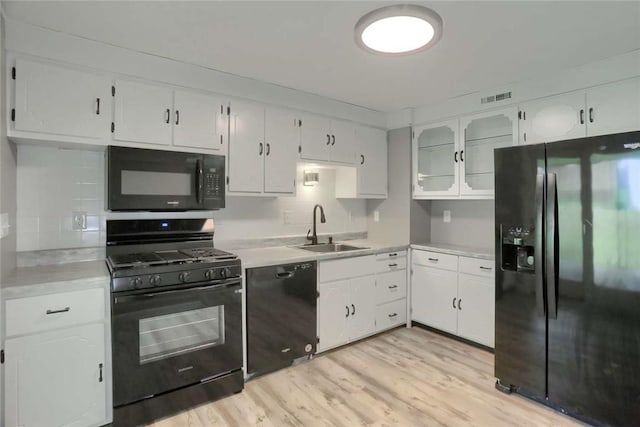 217 Belladonna Dr, Shaler, PA 15116 - kitchen featuring black appliances, light countertops, white cabinets, and light wood-type flooring