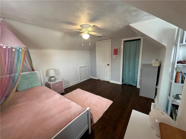 bedroom featuring ceiling fan, lofted ceiling, and dark hardwood / wood-style floors