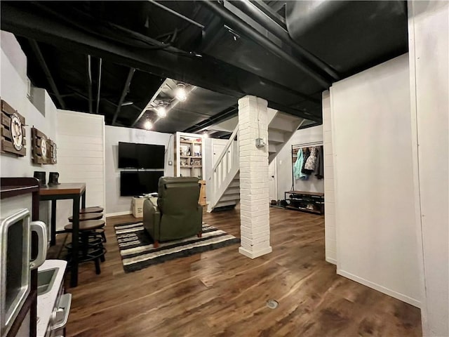 basement with dark hardwood / wood-style floors