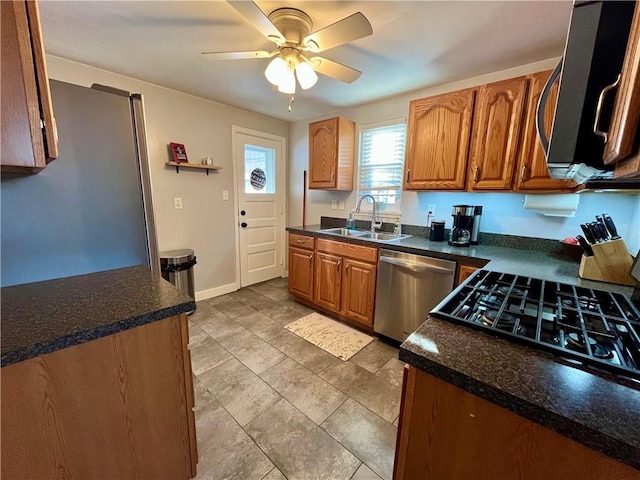 kitchen with sink, stainless steel dishwasher, black range with gas stovetop, and ceiling fan