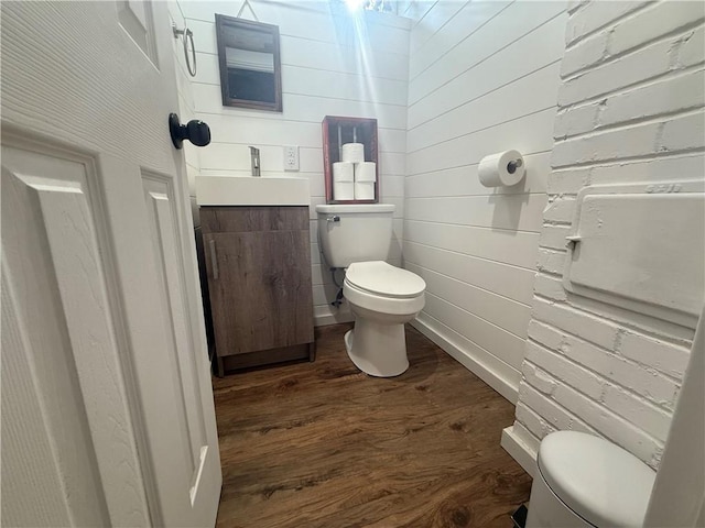 bathroom with vanity, hardwood / wood-style flooring, and toilet