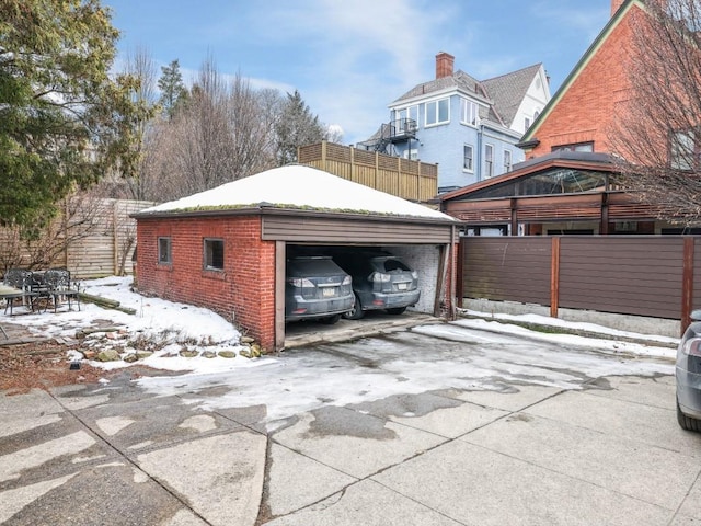 view of snow covered exterior featuring a carport