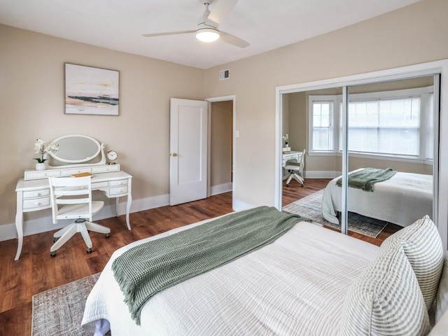 bedroom with ceiling fan, dark hardwood / wood-style floors, and a closet