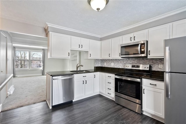 kitchen featuring sink, a textured ceiling, stainless steel appliances, and white cabinets