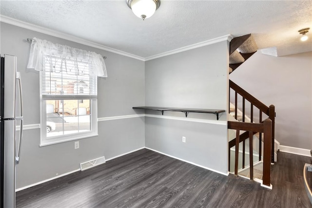 interior space with dark hardwood / wood-style flooring, crown molding, and a textured ceiling