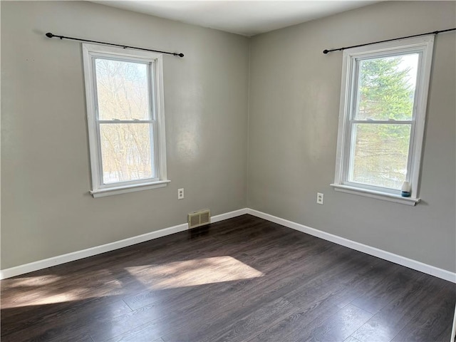 empty room featuring dark hardwood / wood-style flooring