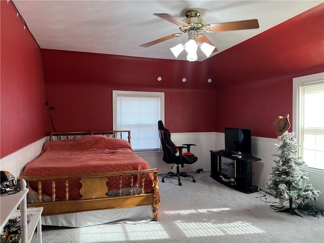 bedroom featuring light colored carpet and ceiling fan