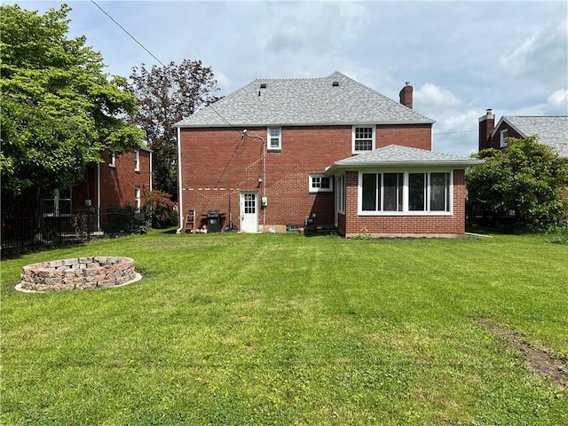 1410 Union Ave, Natrona Hts/Harrison Twp, PA 15065 - back of property featuring an outdoor fire pit, a chimney, brick siding, and roof with shingles