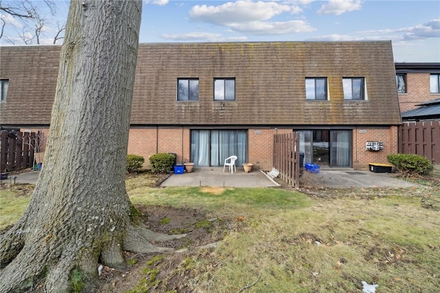 rear view of house featuring a patio area and a lawn