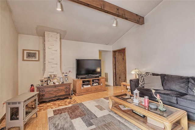 living room with vaulted ceiling with beams and light hardwood / wood-style floors