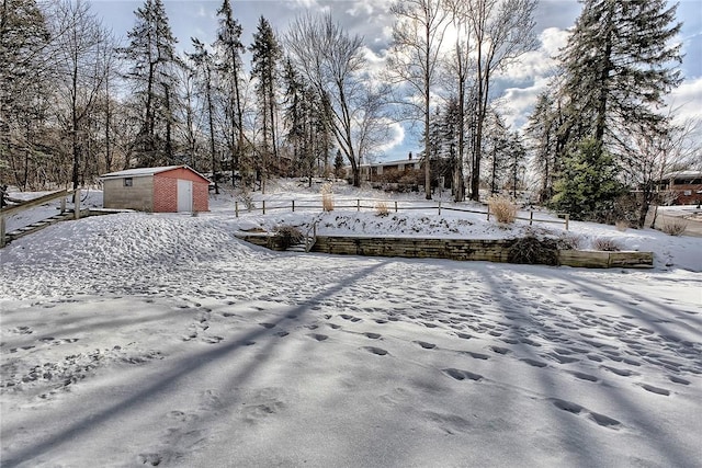 yard covered in snow featuring a storage unit