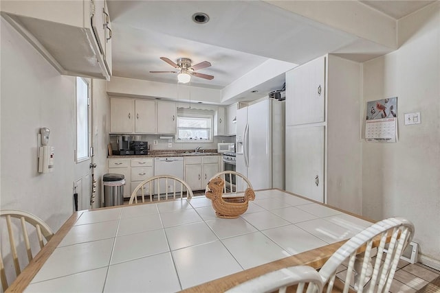 dining space with light tile patterned floors and ceiling fan