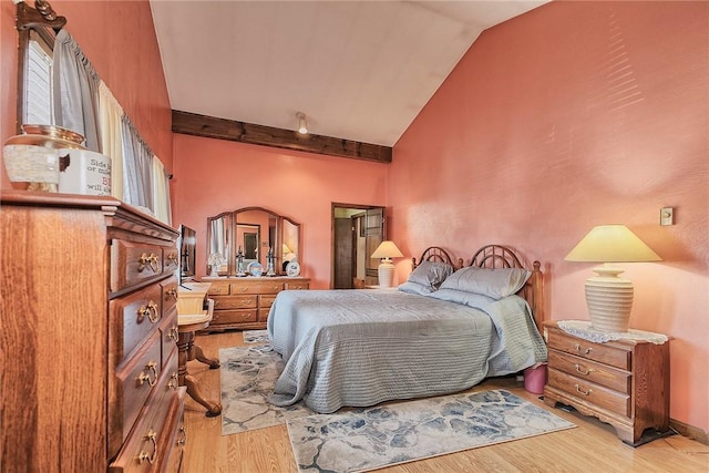 bedroom with vaulted ceiling and light hardwood / wood-style floors