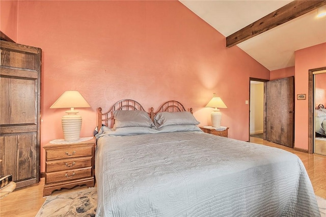 bedroom with vaulted ceiling with beams and light wood-type flooring