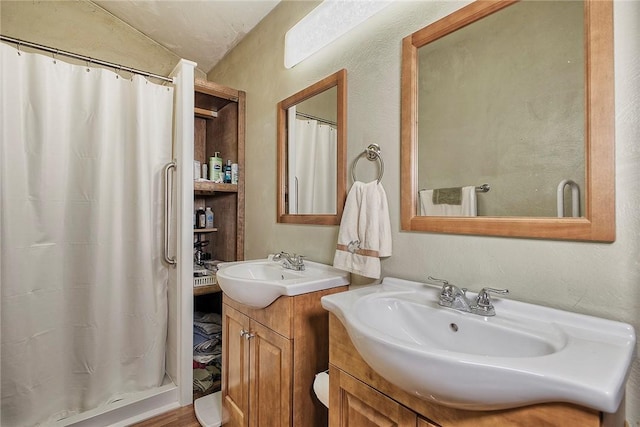 bathroom featuring vanity and curtained shower