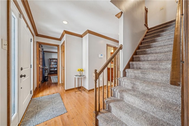 entryway with recessed lighting, baseboards, stairway, light wood-type flooring, and crown molding