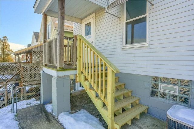 snow covered property entrance featuring central AC