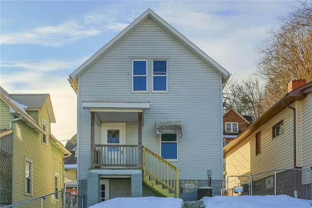 view of snow covered rear of property