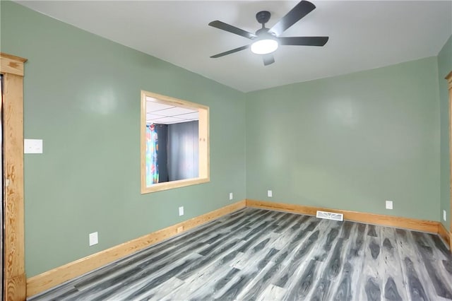 spare room with hardwood / wood-style flooring and ceiling fan