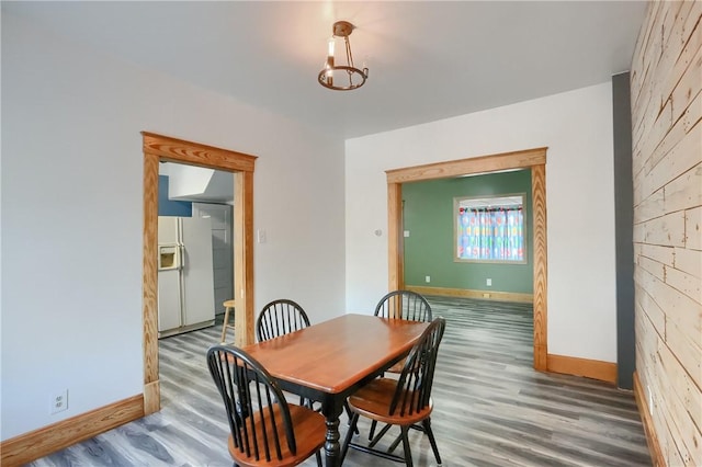 dining space with wood-type flooring