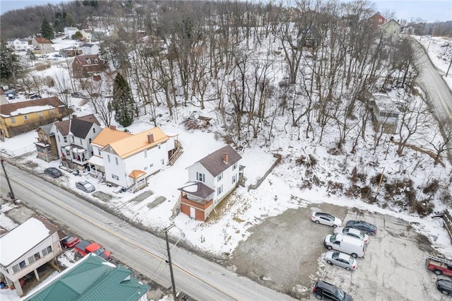 snowy aerial view with a residential view