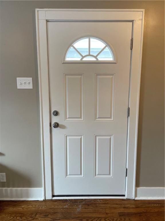 interior space featuring baseboards and wood finished floors