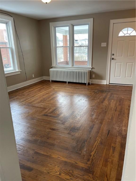 entryway featuring radiator heating unit and baseboards