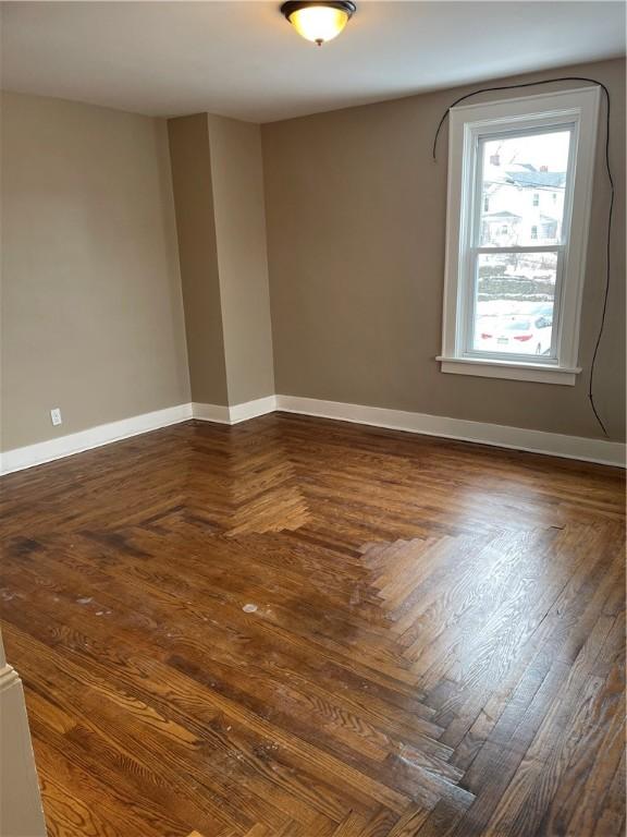 empty room featuring baseboards