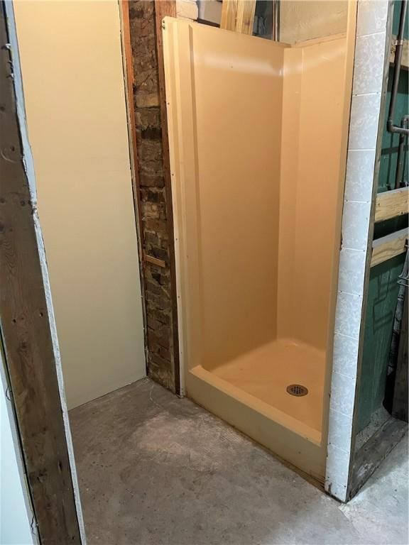 full bath featuring concrete flooring and a stall shower