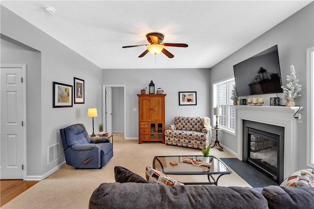 living room featuring light carpet and ceiling fan