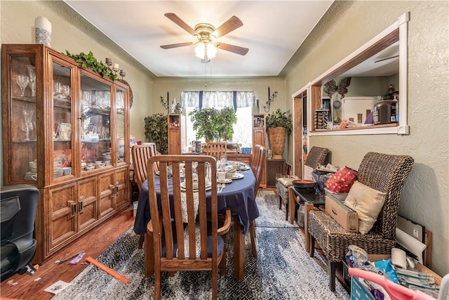 dining area with hardwood / wood-style flooring and ceiling fan