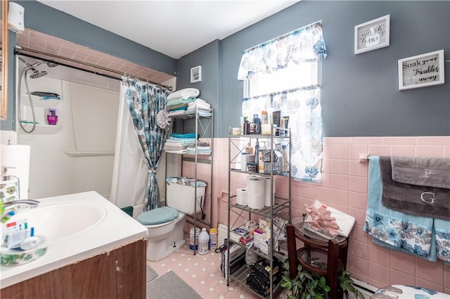 bathroom with vanity, toilet, a shower with shower curtain, and tile walls