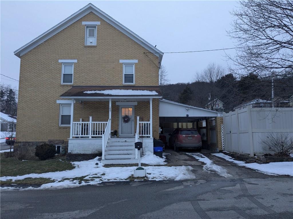 front of property featuring a carport and covered porch