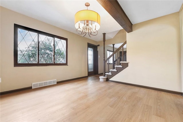 foyer entrance with a notable chandelier, hardwood / wood-style floors, and beamed ceiling