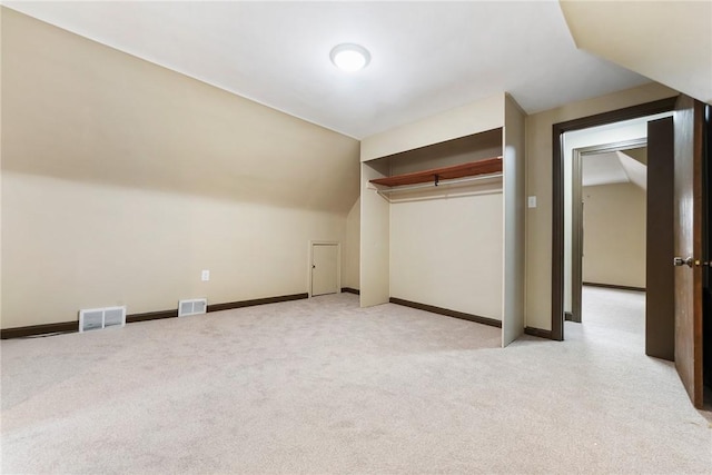 bonus room featuring vaulted ceiling and light carpet