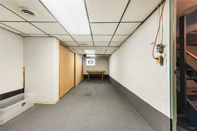 basement featuring a paneled ceiling